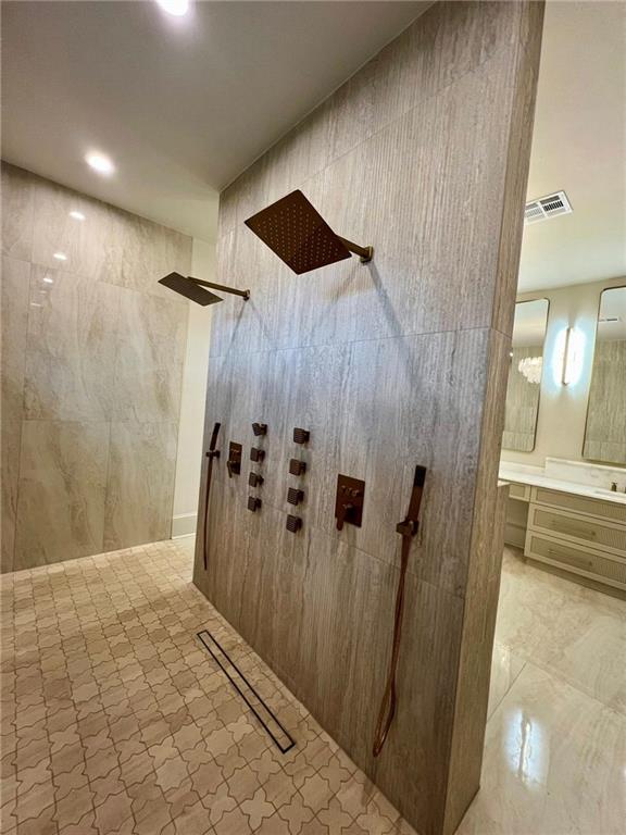 138 Wood Duck Dr, Belle Chasse, LA 70037 - detailed view of a walk in shower, vanity, and recessed lighting