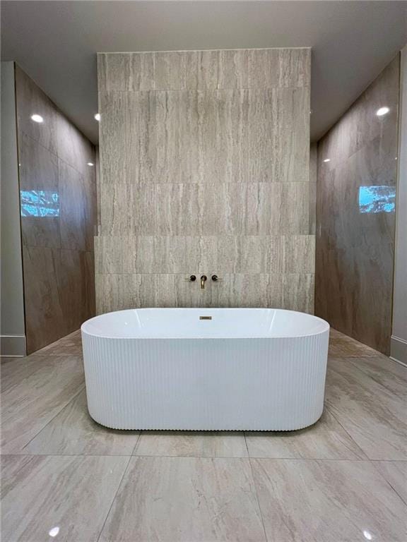 138 Wood Duck Dr, Belle Chasse, LA 70037 - bathroom with a soaking tub, marble finish flooring, and a walk in shower