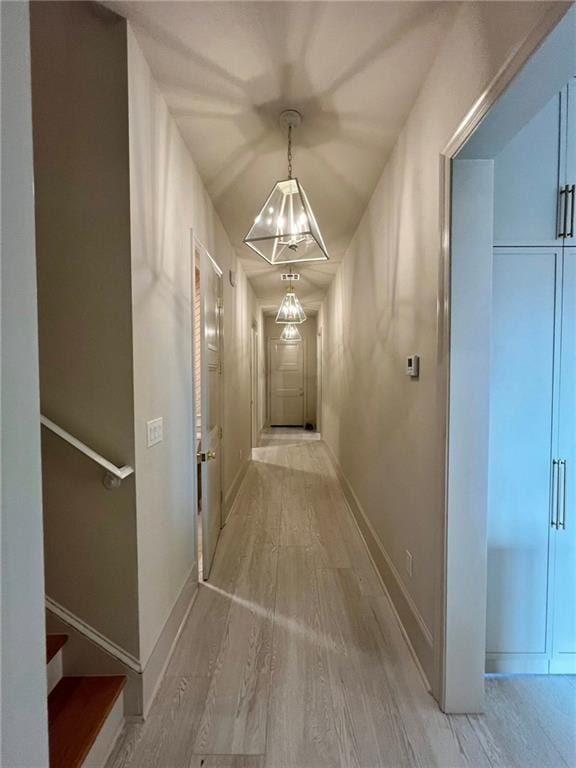 138 Wood Duck Dr, Belle Chasse, LA 70037 - corridor with light wood-type flooring and a chandelier
