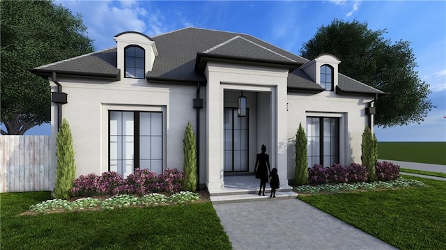 french country inspired facade featuring stucco siding, a front lawn, and fence