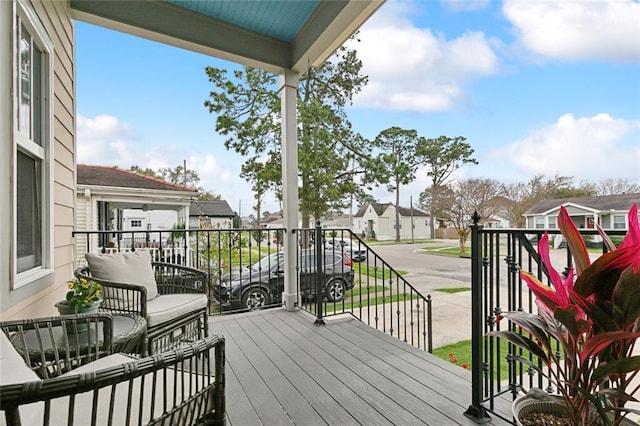 wooden deck featuring a residential view