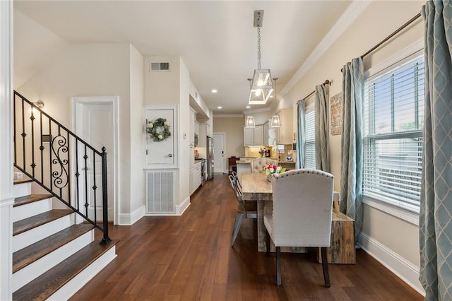 dining space featuring baseboards, visible vents, dark wood-style flooring, and ornamental molding