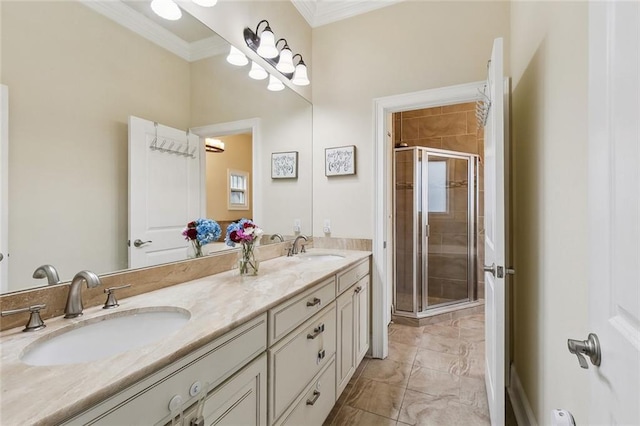 full bath with a sink, a shower stall, crown molding, and double vanity