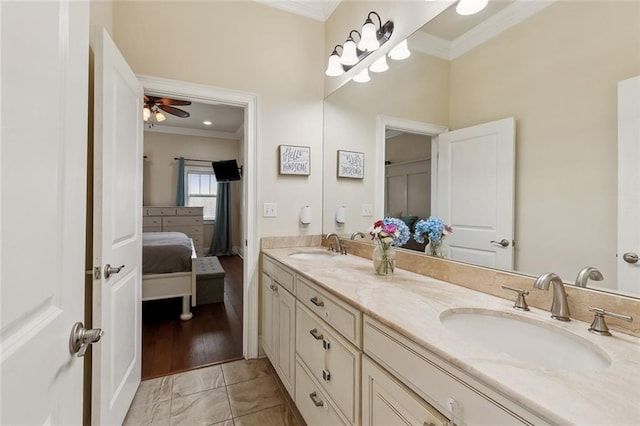 full bathroom with double vanity, ornamental molding, connected bathroom, and a sink