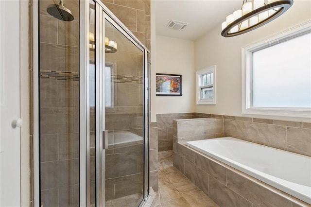 bathroom with visible vents, a garden tub, and a stall shower