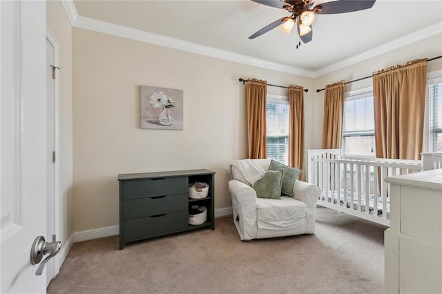 bedroom with ceiling fan, crown molding, baseboards, and light carpet