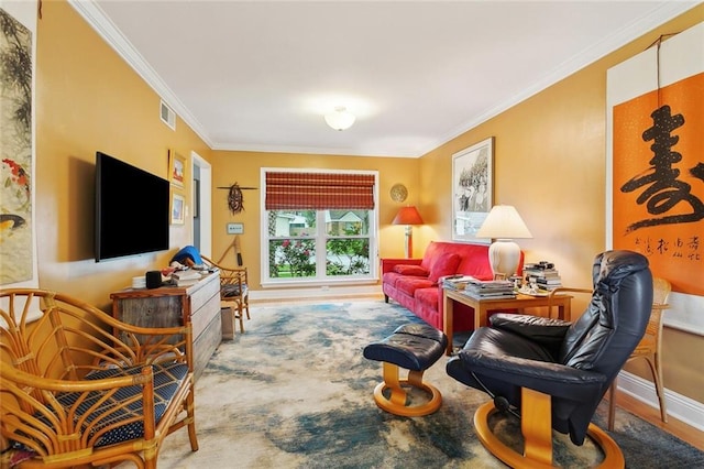 living room featuring wood finished floors, baseboards, visible vents, and ornamental molding