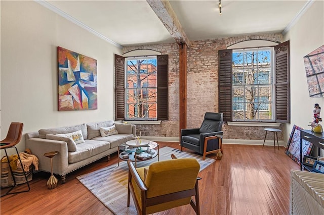 living room featuring crown molding, baseboards, and wood-type flooring