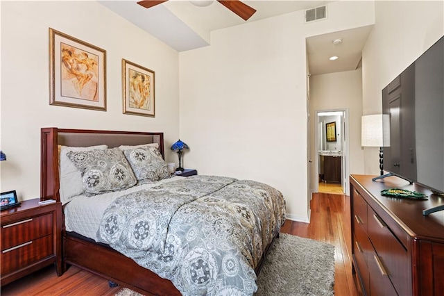 bedroom with visible vents, ceiling fan, baseboards, and wood finished floors