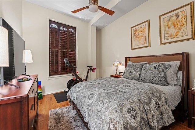 bedroom featuring wood finished floors and baseboards