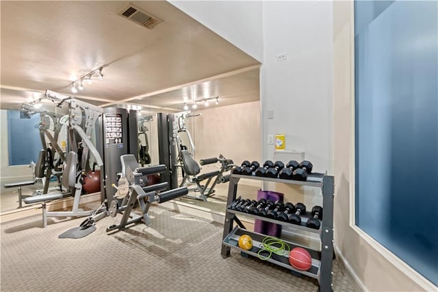 gym featuring visible vents, baseboards, and track lighting