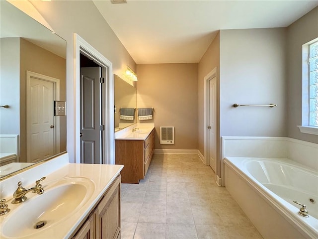 full bath featuring two vanities, a sink, tile patterned flooring, baseboards, and a bath