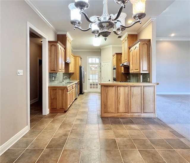 kitchen with tile patterned flooring, baseboards, a chandelier, freestanding refrigerator, and a sink