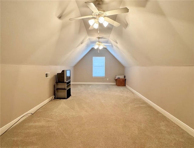 additional living space with vaulted ceiling, carpet flooring, visible vents, and baseboards