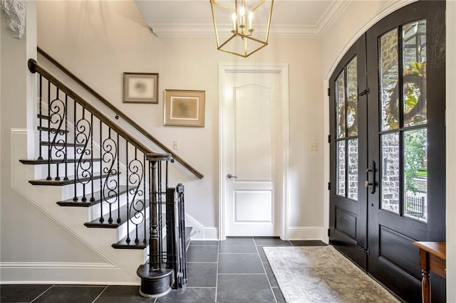 entryway featuring a notable chandelier, french doors, stairs, and dark tile patterned flooring