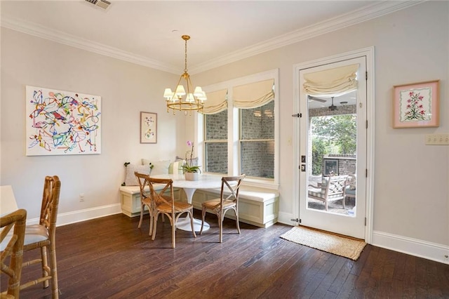 dining area featuring a chandelier, baseboards, dark wood finished floors, and crown molding