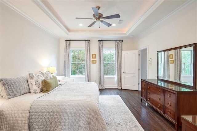 bedroom with visible vents, a ceiling fan, dark wood-style floors, crown molding, and a raised ceiling