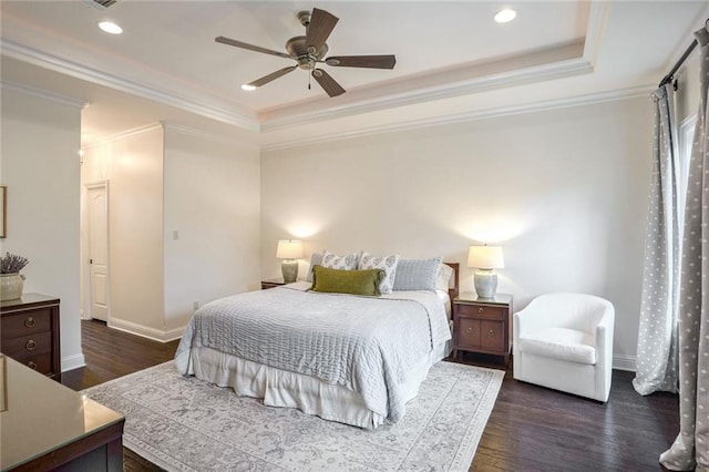 bedroom featuring baseboards, a raised ceiling, and dark wood-type flooring