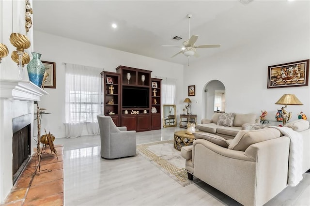5227 Shady Park Dr, Marrero, LA 70072 - living room featuring arched walkways, ceiling fan, a fireplace with raised hearth, and recessed lighting