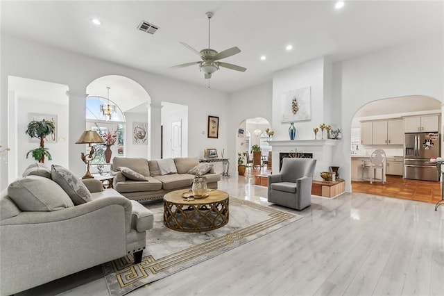 5227 Shady Park Dr, Marrero, LA 70072 - living room featuring arched walkways, ceiling fan, recessed lighting, decorative columns, and light wood-type flooring