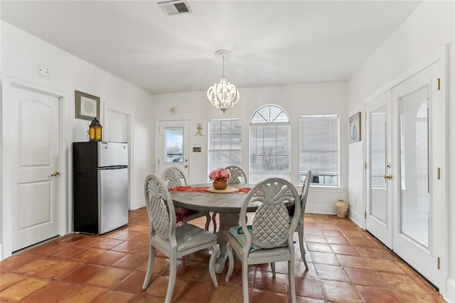 5227 Shady Park Dr, Marrero, LA 70072 - dining area with a chandelier and light tile patterned flooring