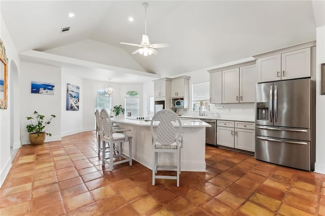 5227 Shady Park Dr, Marrero, LA 70072 - kitchen featuring stainless steel appliances, healthy amount of natural light, a ceiling fan, a kitchen breakfast bar, and lofted ceiling
