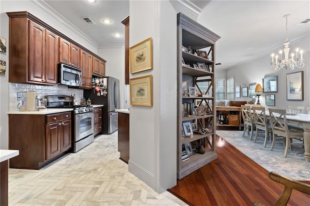 kitchen with visible vents, ornamental molding, backsplash, appliances with stainless steel finishes, and light countertops