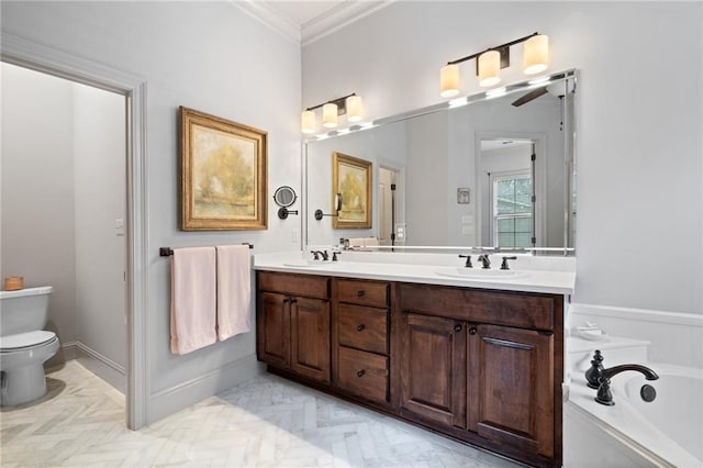 full bath featuring toilet, a sink, crown molding, double vanity, and a bath