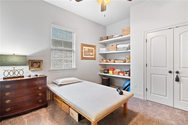 bedroom with light colored carpet, a ceiling fan, and a closet