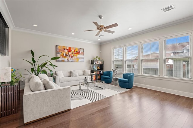 living area featuring wood finished floors, a ceiling fan, visible vents, and ornamental molding