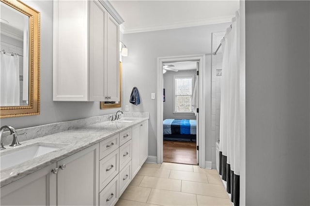 bathroom featuring double vanity, tile patterned flooring, ornamental molding, and a sink