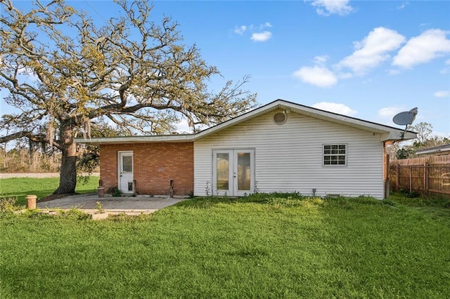 105 Palm Springs Dr, Slidell, LA 70458 - rear view of house with brick siding, french doors, a yard, and fence