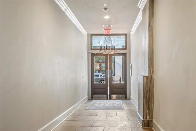 220 Decatur St Unit 206, New Orleans, LA 70130 - entrance foyer with a chandelier, stone tile flooring, ornamental molding, french doors, and recessed lighting