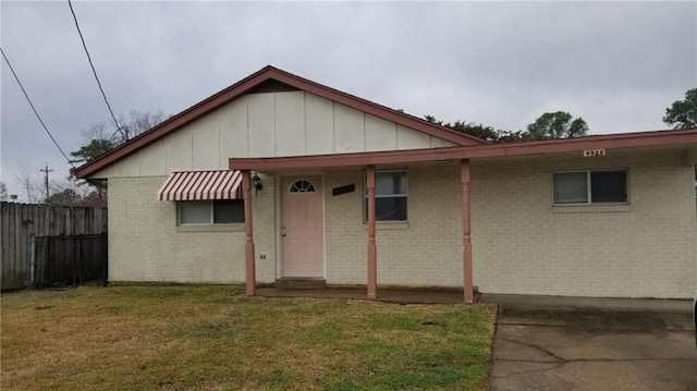 4928 Sandalwood St, New Orleans, LA 70127 - view of front of home with a front lawn, fence, and brick siding