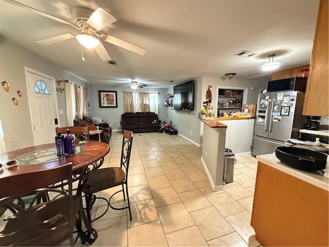 4928 Sandalwood St, New Orleans, LA 70127 - dining room featuring light tile patterned floors, visible vents, baseboards, and a ceiling fan