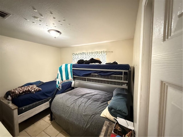 4928 Sandalwood St, New Orleans, LA 70127 - tiled bedroom with visible vents and a textured ceiling