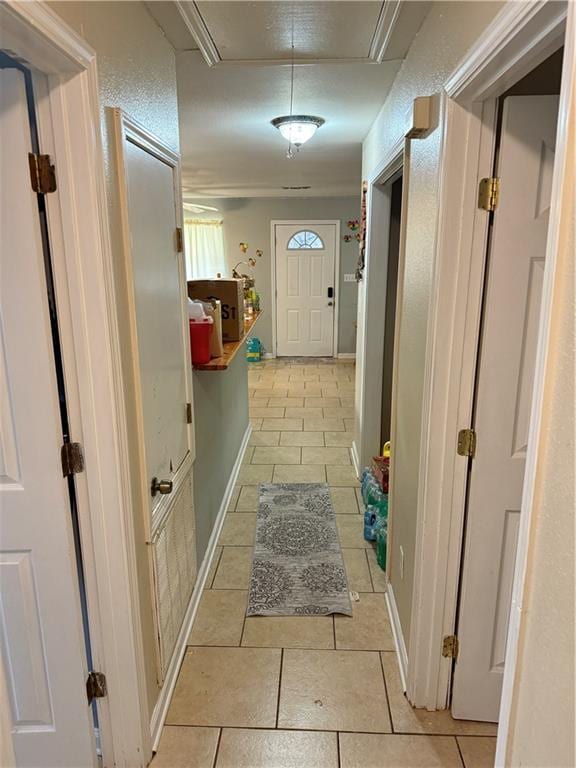 4928 Sandalwood St, New Orleans, LA 70127 - hall with light tile patterned floors, baseboards, and attic access