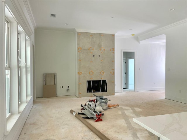 1169 Fox Sparrow Loop, Madisonville, LA 70447 - unfurnished living room with healthy amount of natural light, crown molding, and a tiled fireplace