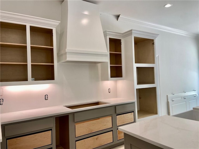 1169 Fox Sparrow Loop, Madisonville, LA 70447 - kitchen featuring wall chimney range hood, crown molding, light stone counters, and black electric stovetop