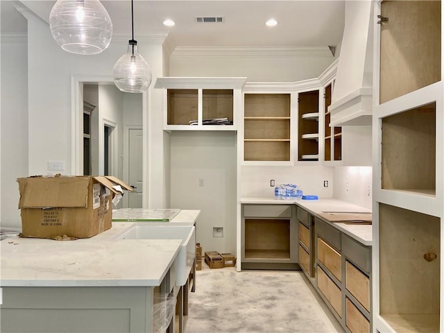 1169 Fox Sparrow Loop, Madisonville, LA 70447 - kitchen featuring crown molding, hanging light fixtures, light stone countertops, and open shelves