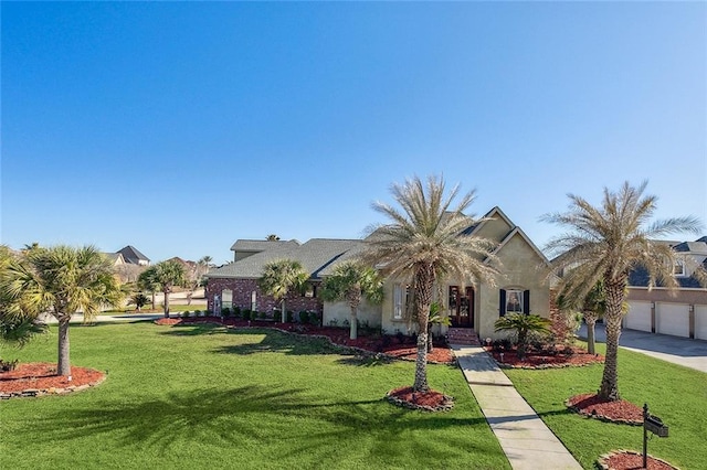 318 Cape Breton Dr, Slidell, LA 70458 - view of front of home featuring stucco siding, a front yard, and driveway