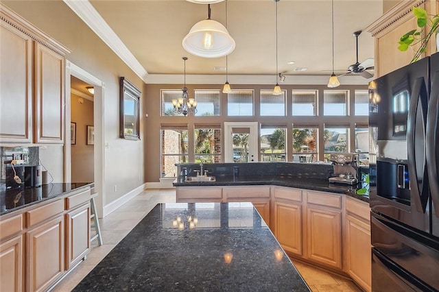 318 Cape Breton Dr, Slidell, LA 70458 - kitchen with light brown cabinetry, dark stone countertops, black appliances, and ornamental molding