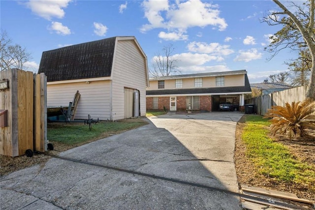 119 Vine St, New Iberia, LA 70560 - view of front of home featuring an outdoor structure, a gambrel roof, driveway, and a barn