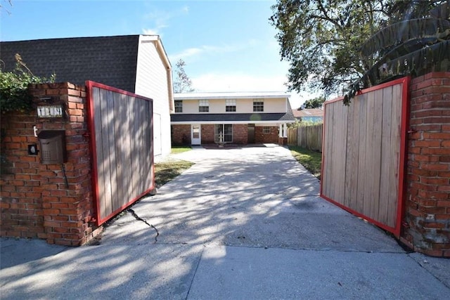 119 Vine St, New Iberia, LA 70560 - view of property exterior with a shingled roof, driveway, and brick siding