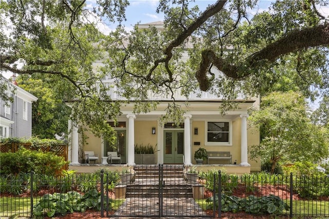 1930 Napoleon Ave, New Orleans, LA 70115 - neoclassical home with french doors, a fenced front yard, and stucco siding