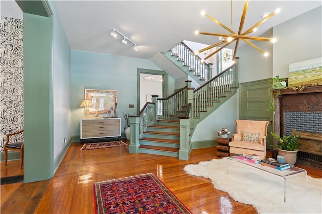 1930 Napoleon Ave, New Orleans, LA 70115 - entryway featuring stairway, a fireplace with flush hearth, wood finished floors, and rail lighting