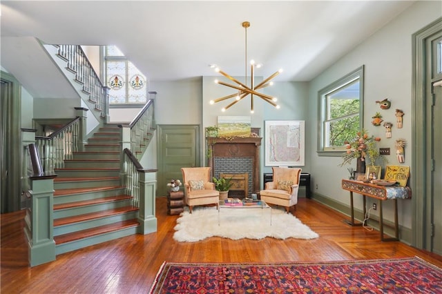 1930 Napoleon Ave, New Orleans, LA 70115 - living area featuring stairs, a chandelier, a fireplace, and wood finished floors