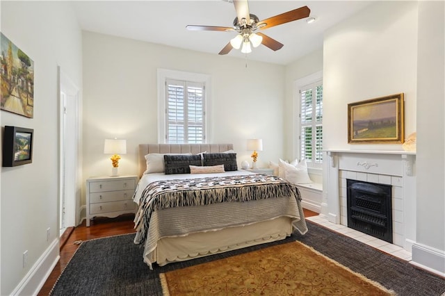 1930 Napoleon Ave, New Orleans, LA 70115 - bedroom with a tile fireplace, wood finished floors, and a ceiling fan