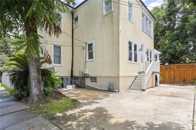 1930 Napoleon Ave, New Orleans, LA 70115 - view of property exterior with a patio area, stucco siding, and stairway
