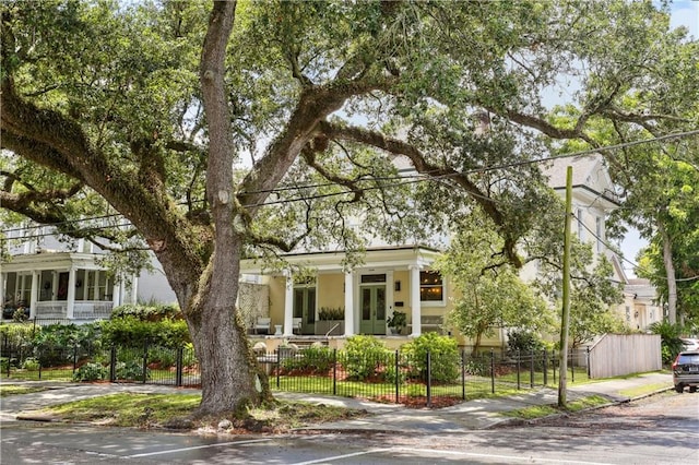 1930 Napoleon Ave, New Orleans, LA 70115 - obstructed view of property with a fenced front yard, french doors, and stucco siding